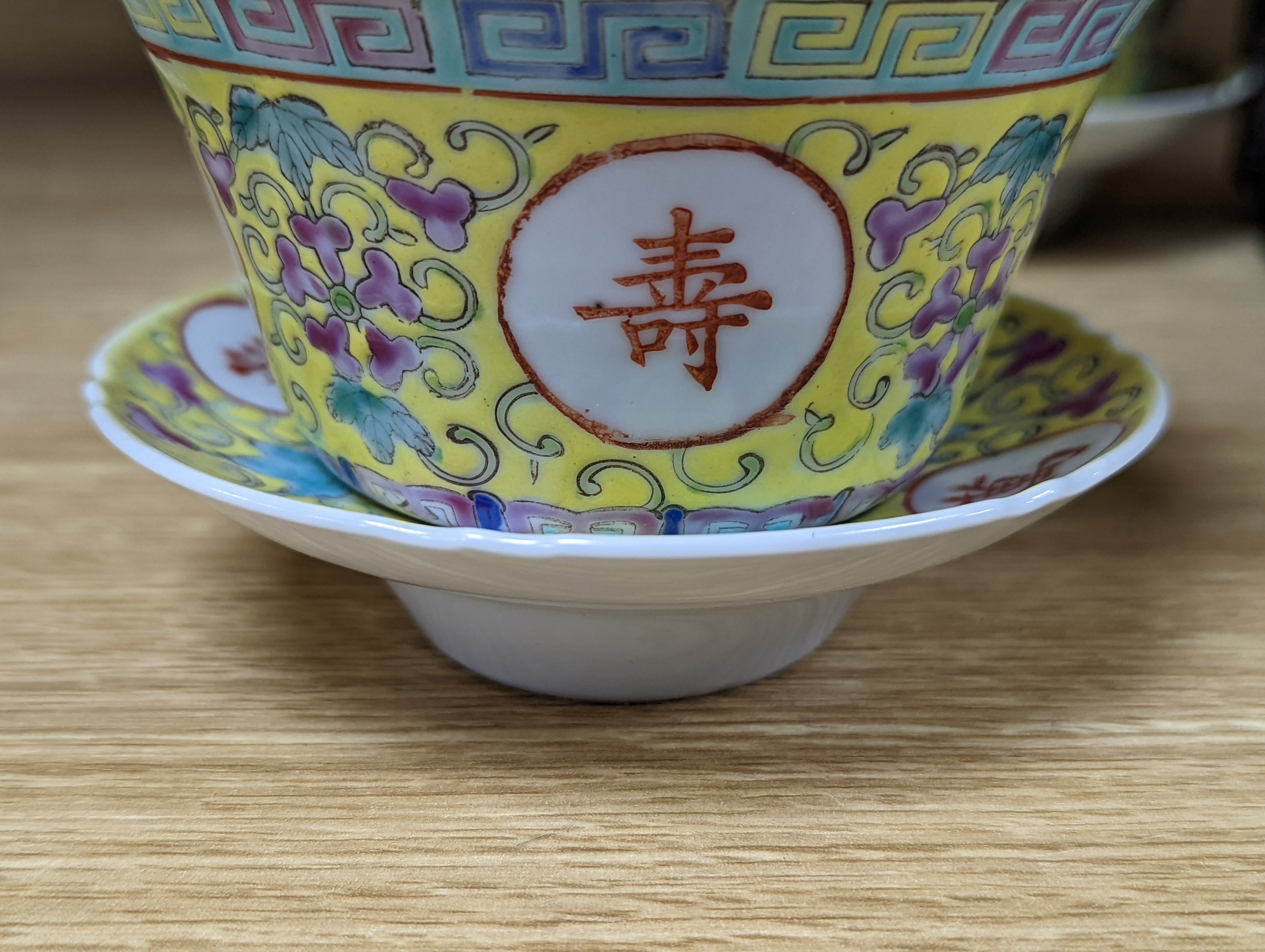A pair of Chinese enamelled porcelain rice bowls, covers and stands and an odd bowl